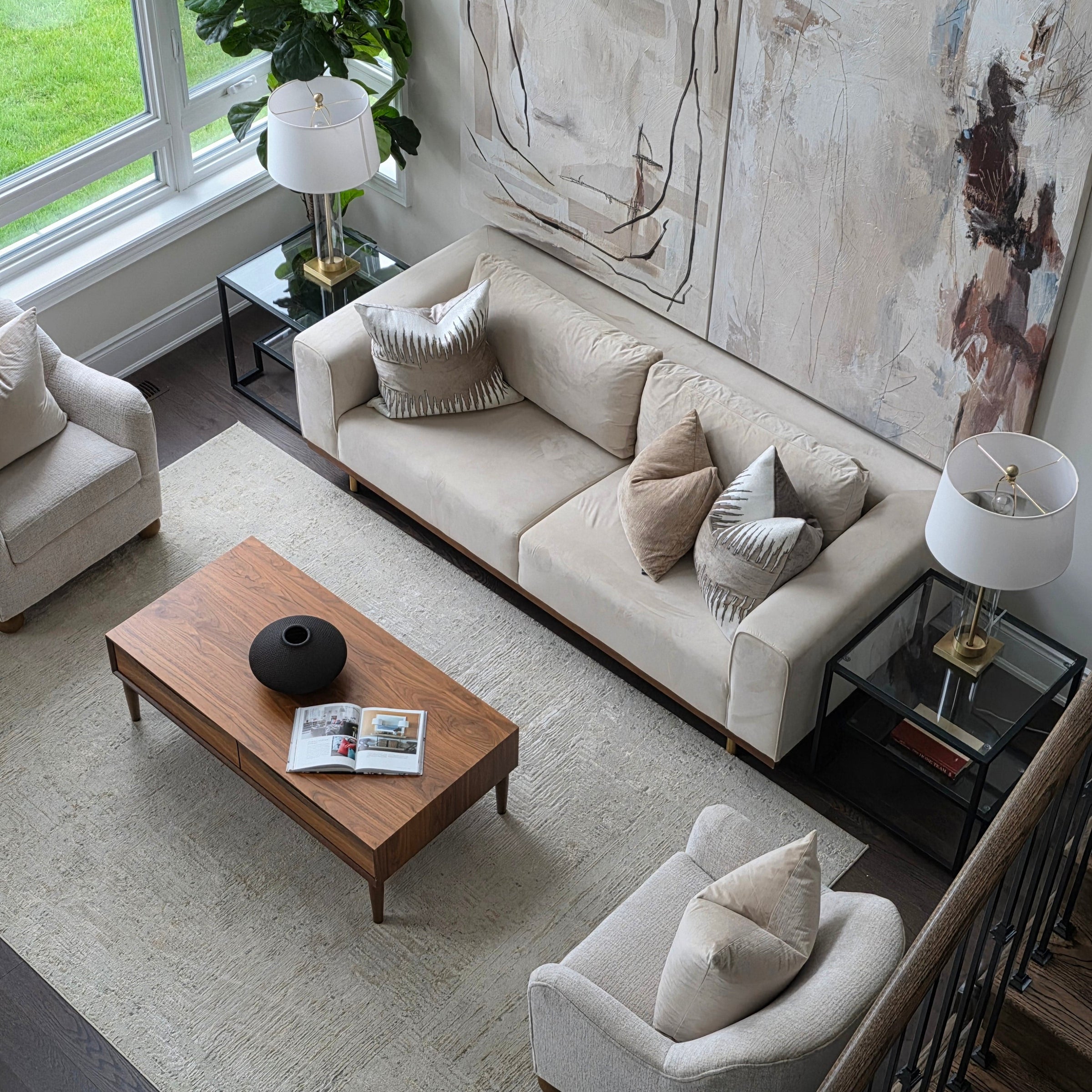 Modern living room with beige sofa, wooden coffee table, and decorative items.